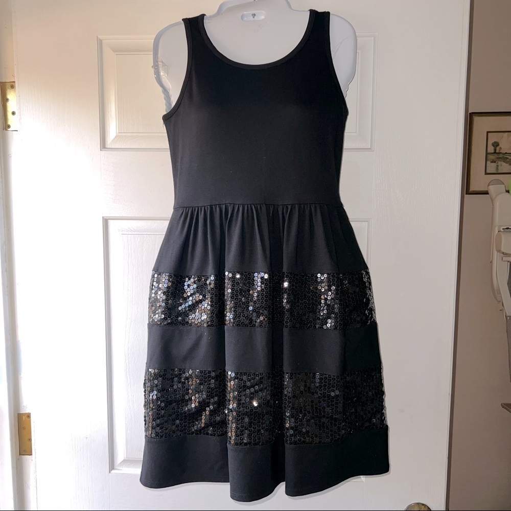 STYLISH Girl’s sleeveless black dress by Justice accented with bands of sequins.